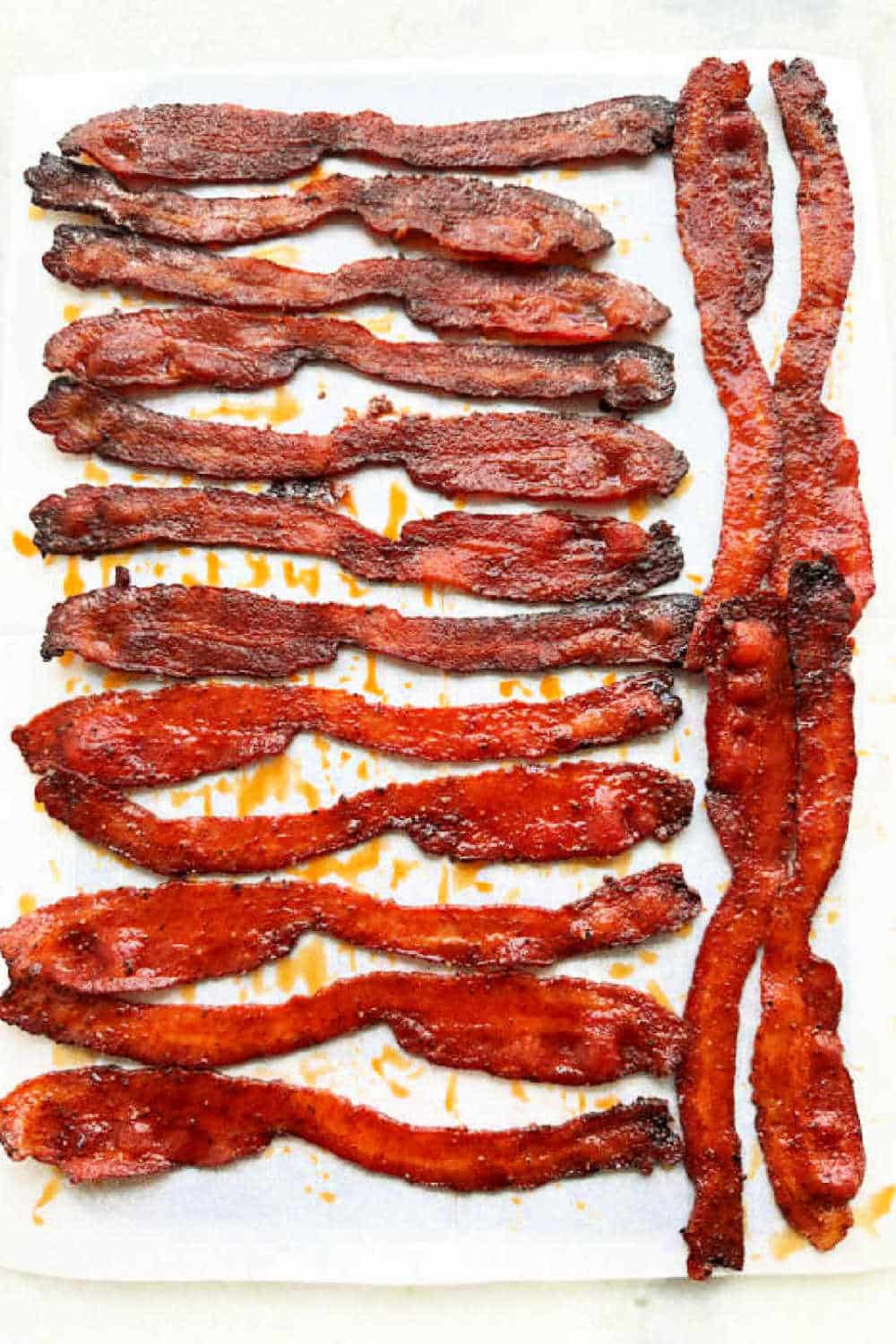 My easy bacon candy recipe combines brown sugar and spices with a splash of bourbon to easily brush on the bacon before baking. via @foodtasticmom