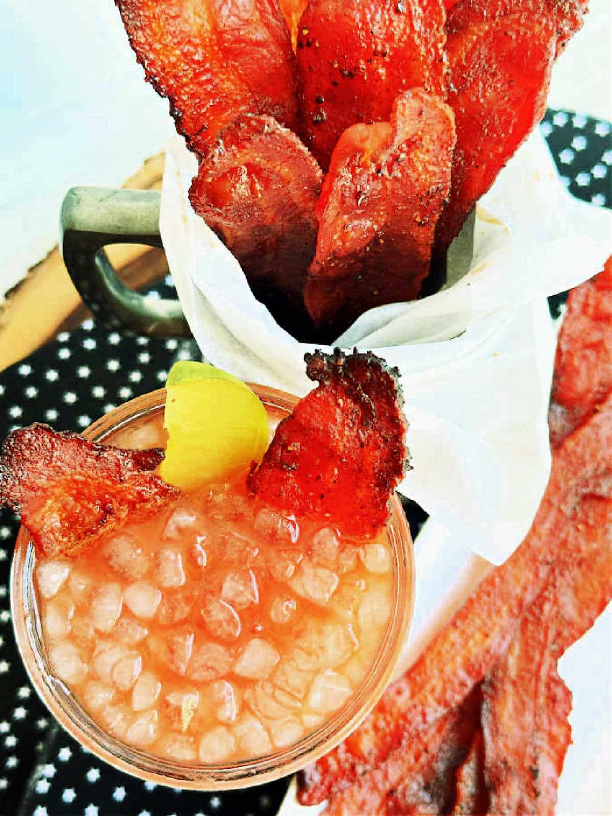 showing bacon candy as a garnish for homemade Bloody Mary cocktail
