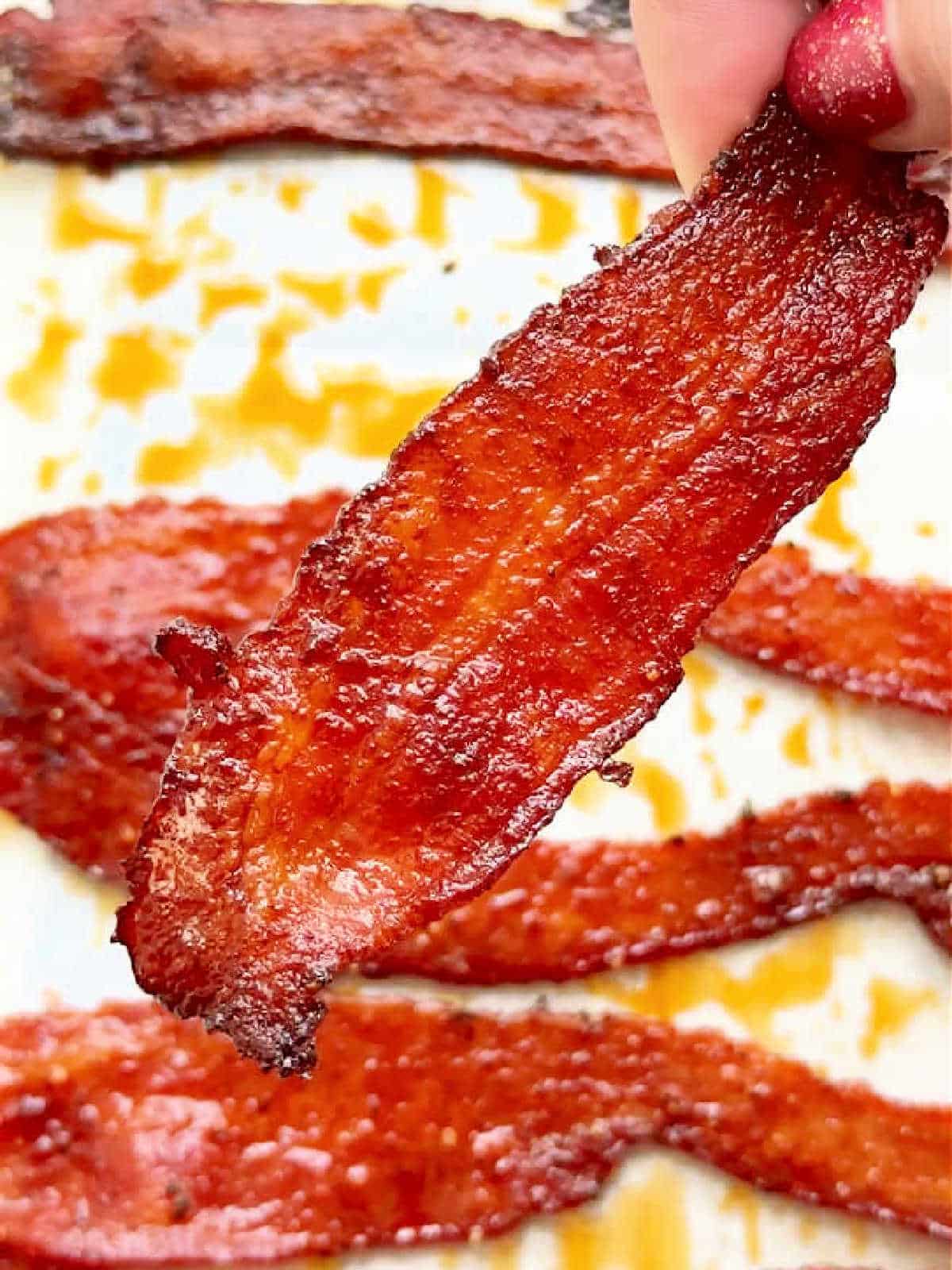holding a strip of bacon candy to show it close up