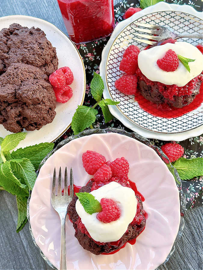 plated raspberry shortcakes topped with fresh raspberries and garnished with mint 