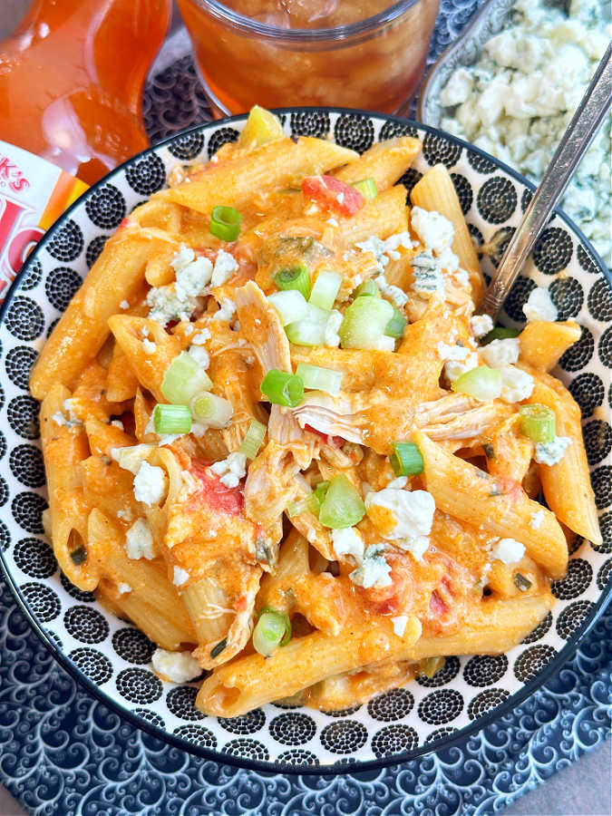 close up view of a big bowl of saucy buffalo chicken pasta