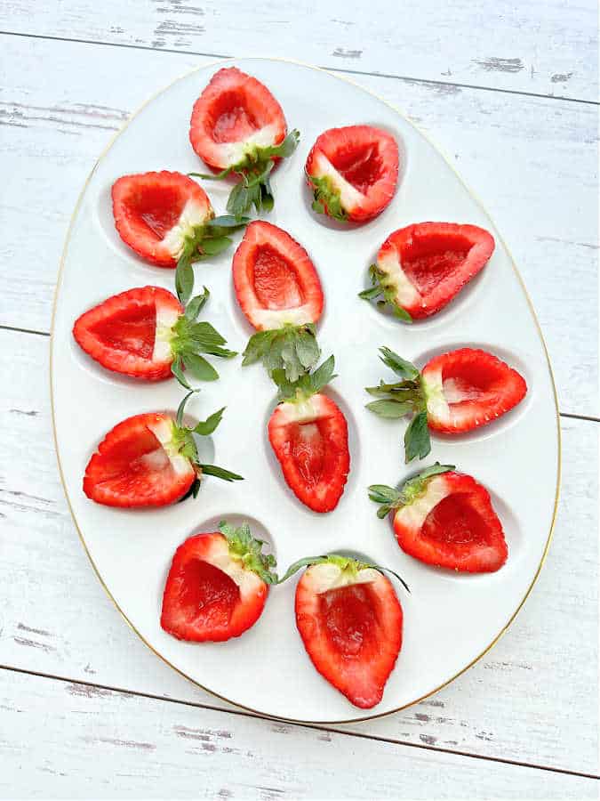 deviled egg platter with hollowed out fresh strawberries, ready to be filled