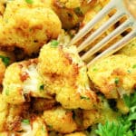 using a fork to take a bite of roasted air fryer cauliflower