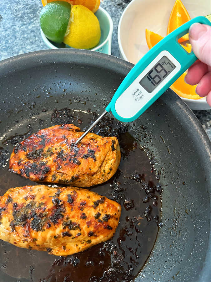 using an instant read thermometer to make sure the citrus marinated chicken is fully cooked