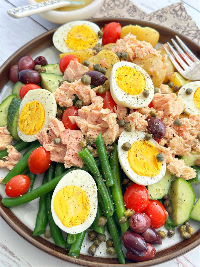 plated tuna nicoise salad with dressing on the side