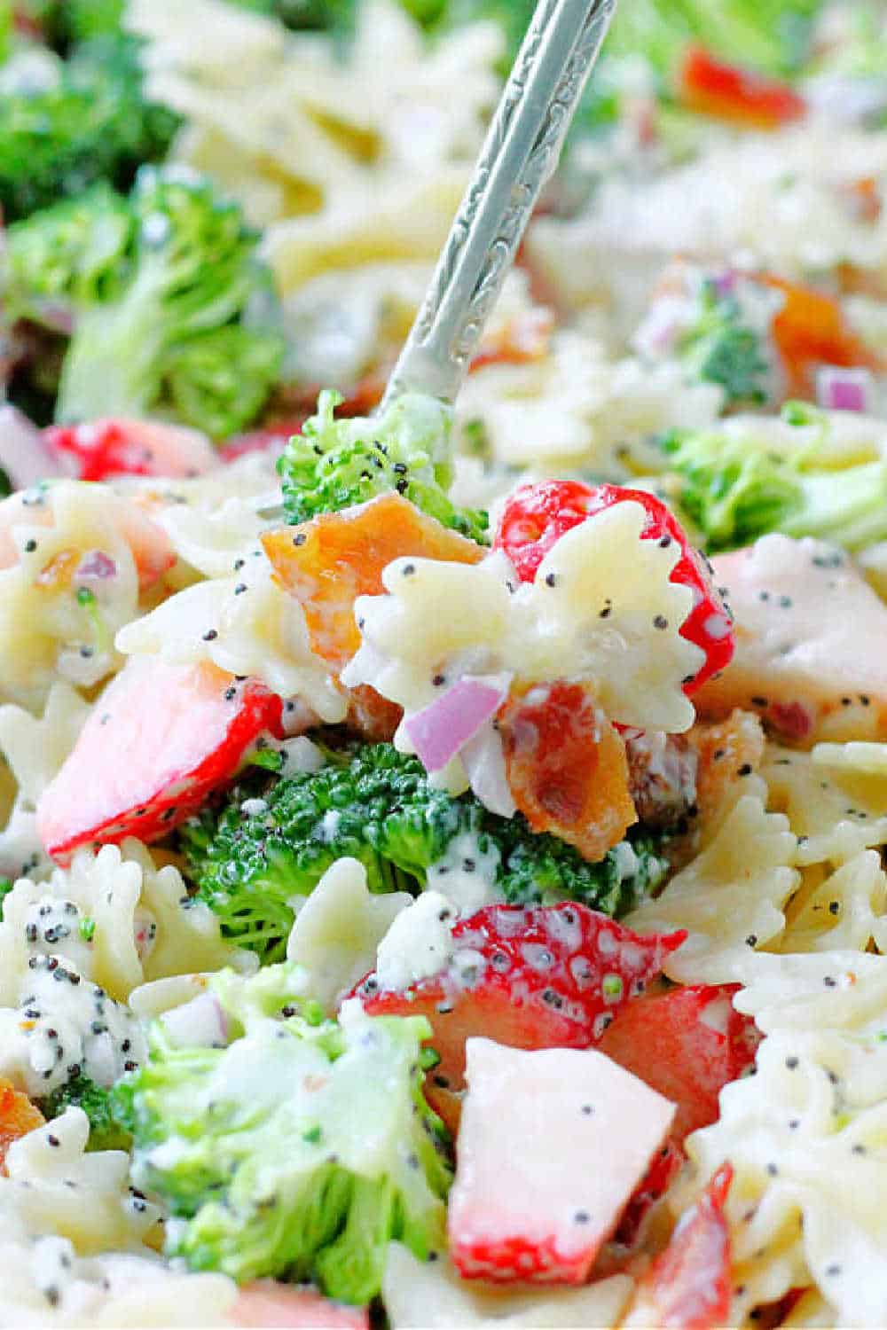 Summer Broccoli Pasta Salad is a terrific take-along dish with a perfect balance of sweet and savory flavors including strawberries and bacon. via @foodtasticmom