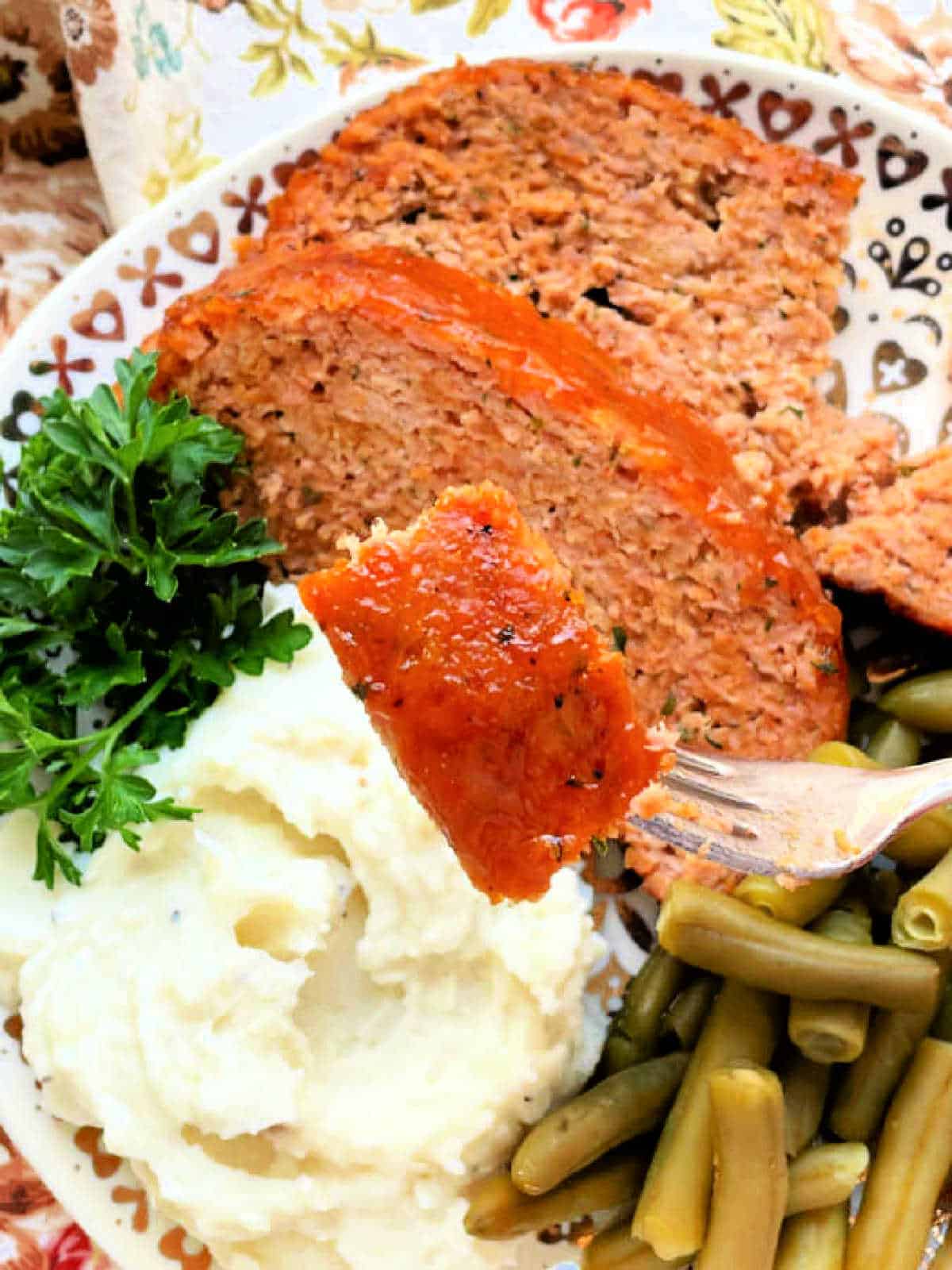 a bite of ham loaf speared on a fork