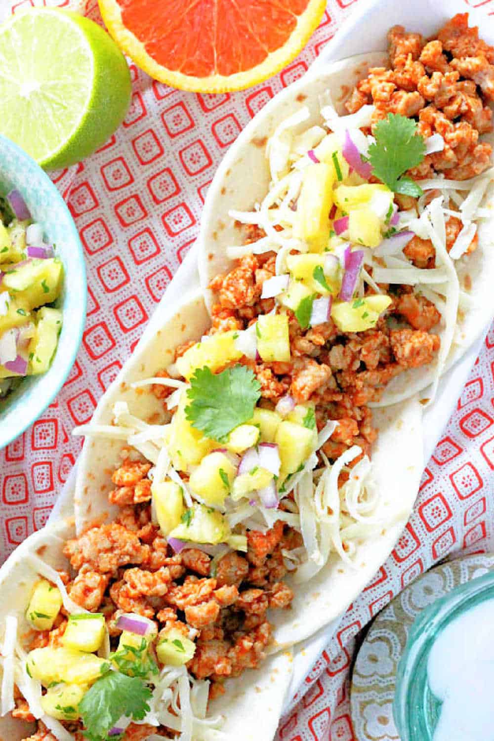 The best Ground Pork Tacos are served Al Pastor style with fresh pineapple salsa and an orange chipotle marinade for the ground pork. via @foodtasticmom