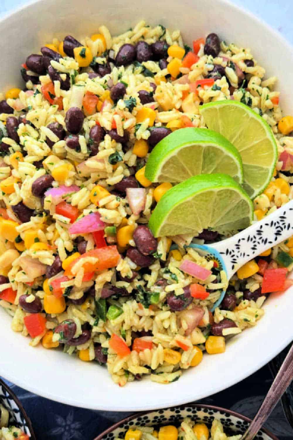 White rice and black beans combine with fresh ingredients and a unique dressing for this crowd pleasing and healthy Bean and Rice Salad. via @foodtasticmom