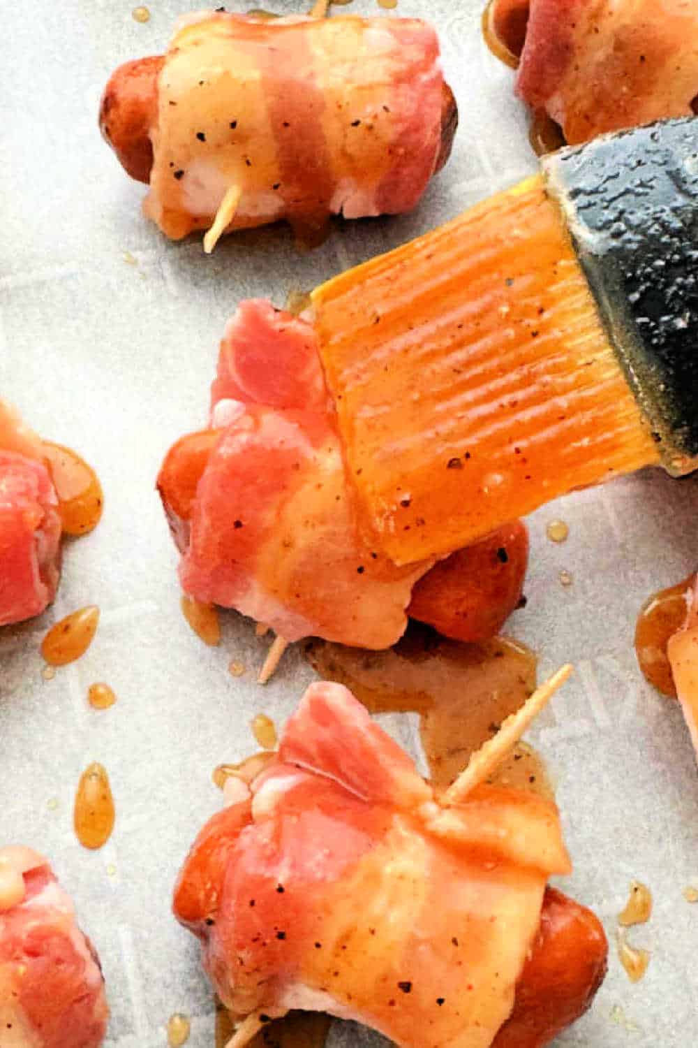 Bacon Wrapped Smokies or lil smokies are a classic appetizer made even better by basting with brown sugar, butter and bourbon. via @foodtasticmom
