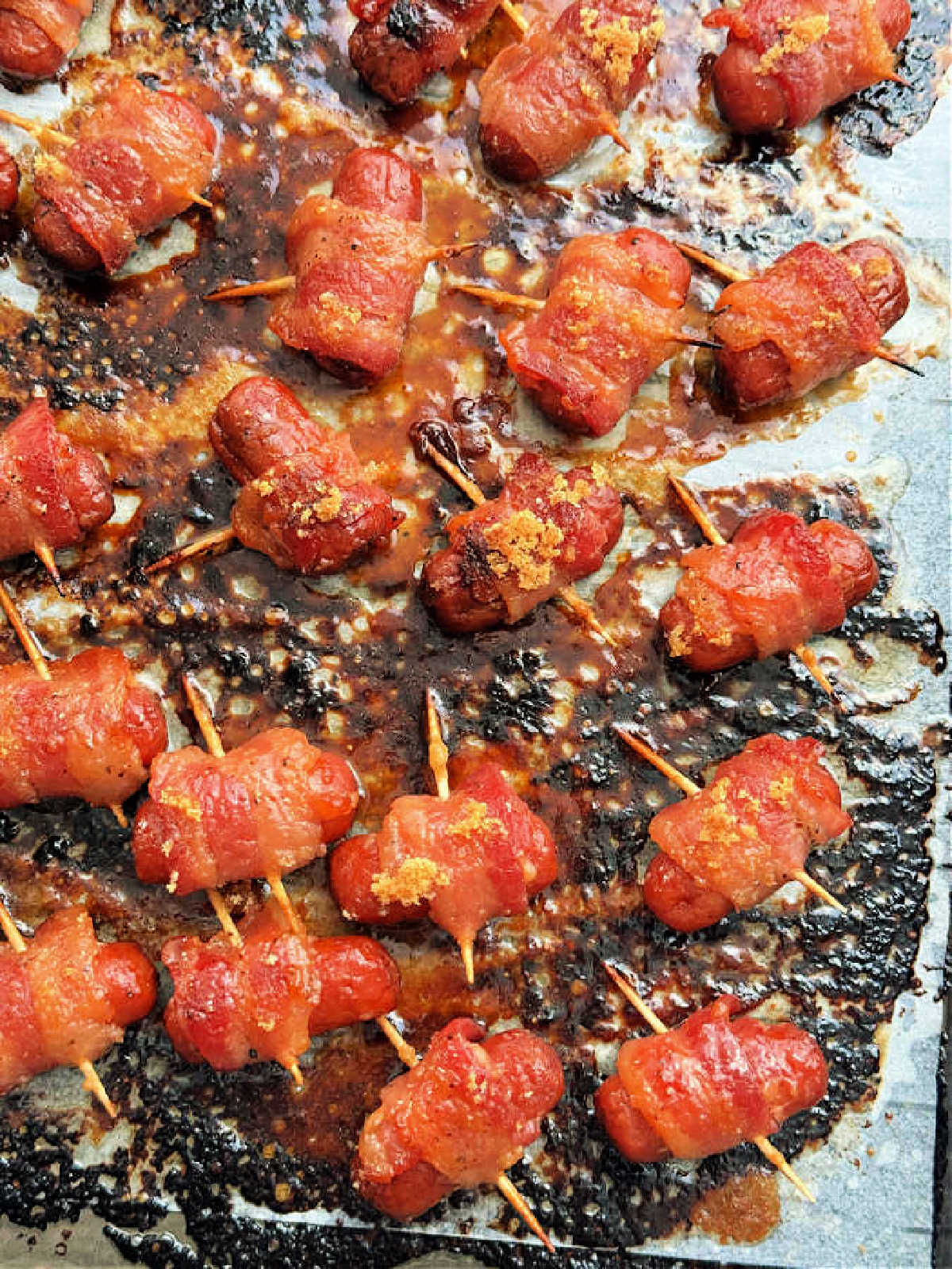 showing the bacon wrapped smokies after being baked on the sheet pan