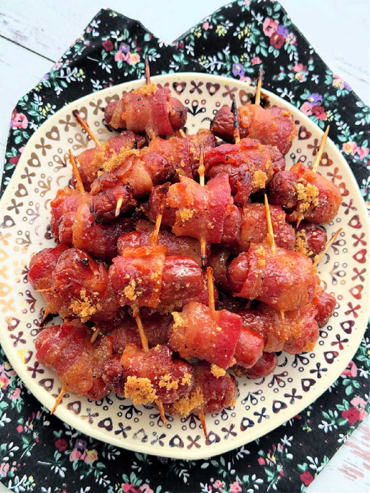 a plateful of bacon wrapped smokies ready to serve