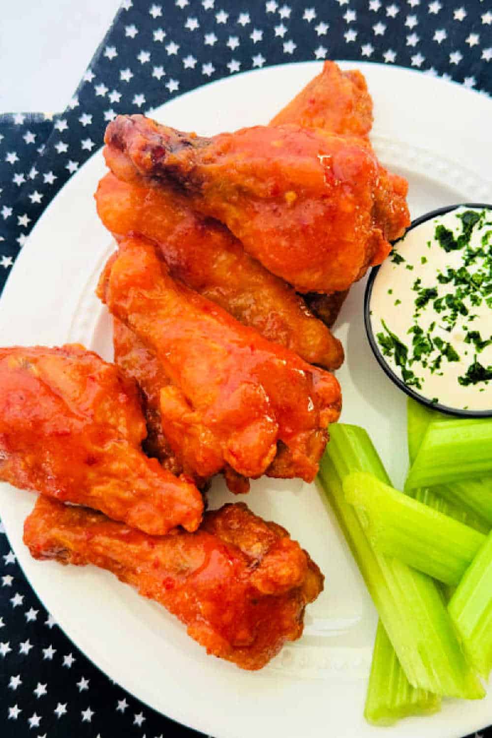 Ditch the deep fryer and make these oven-baked chicken wings that are incredibly crunchy on the outside and juicy on the inside. Using a simple baking powder trick, these wings achieve a perfect, golden, "oven-fried" texture. They are a healthier yet delicious appetizer or main dish for game day, parties, or a satisfying family dinner. via @foodtasticmom