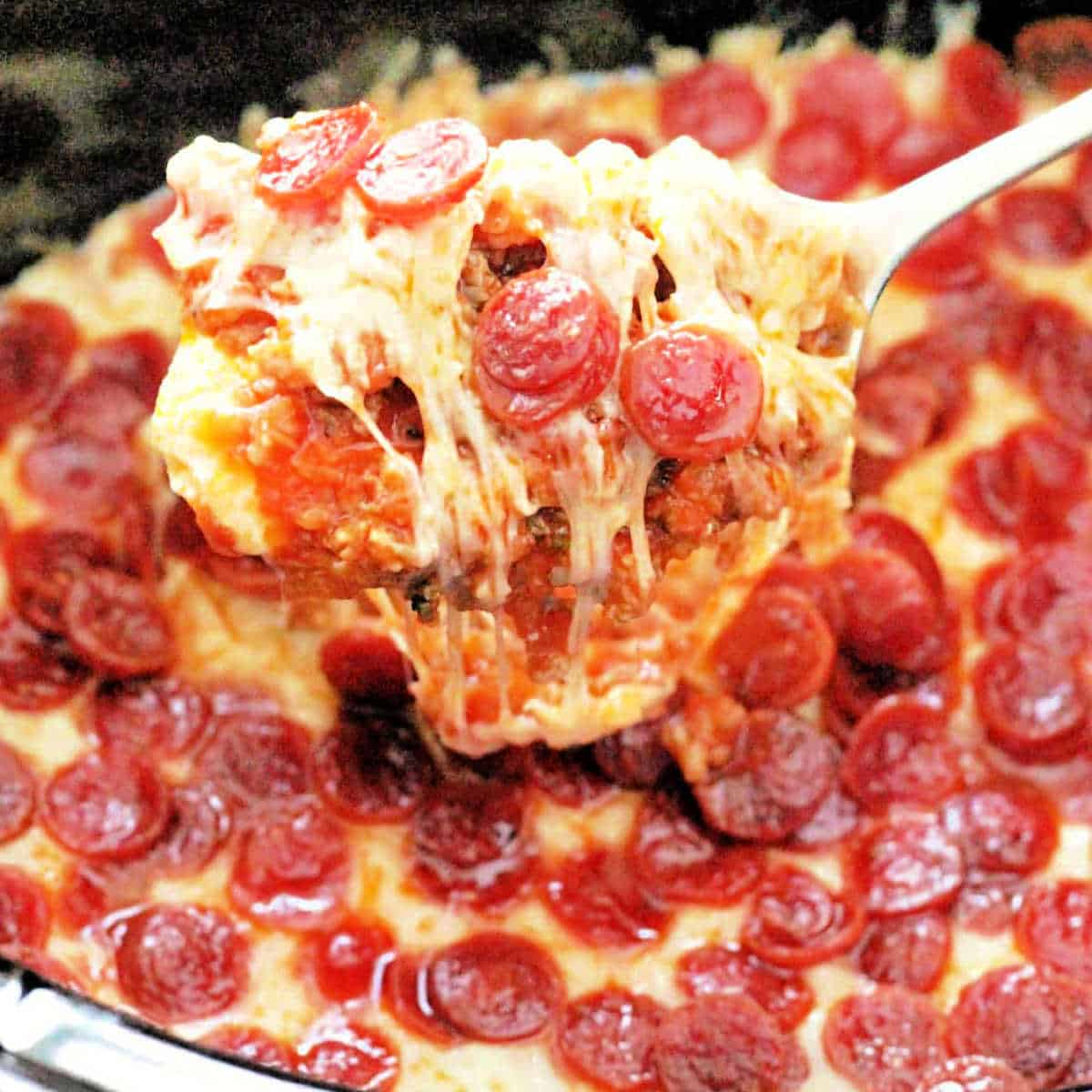 slow cooker pizza dip with pepperoni and melted mozzarella