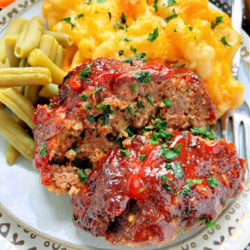 plated slices of meatloaf with mac and cheese and green beans