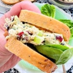 holding half a cranberry chicken salad sandwich with gem lettuce in my hand
