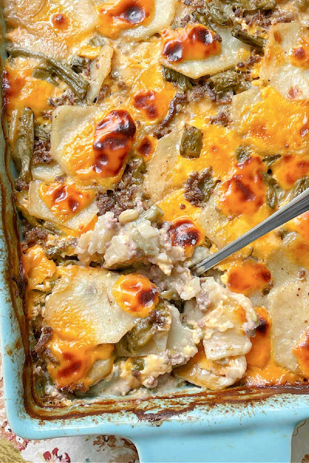 Hamburger Potato Casserole combines potatoes with ground beef and green beans in a velvety cheese sauce. It is pure comfort food. via @foodtasticmom
