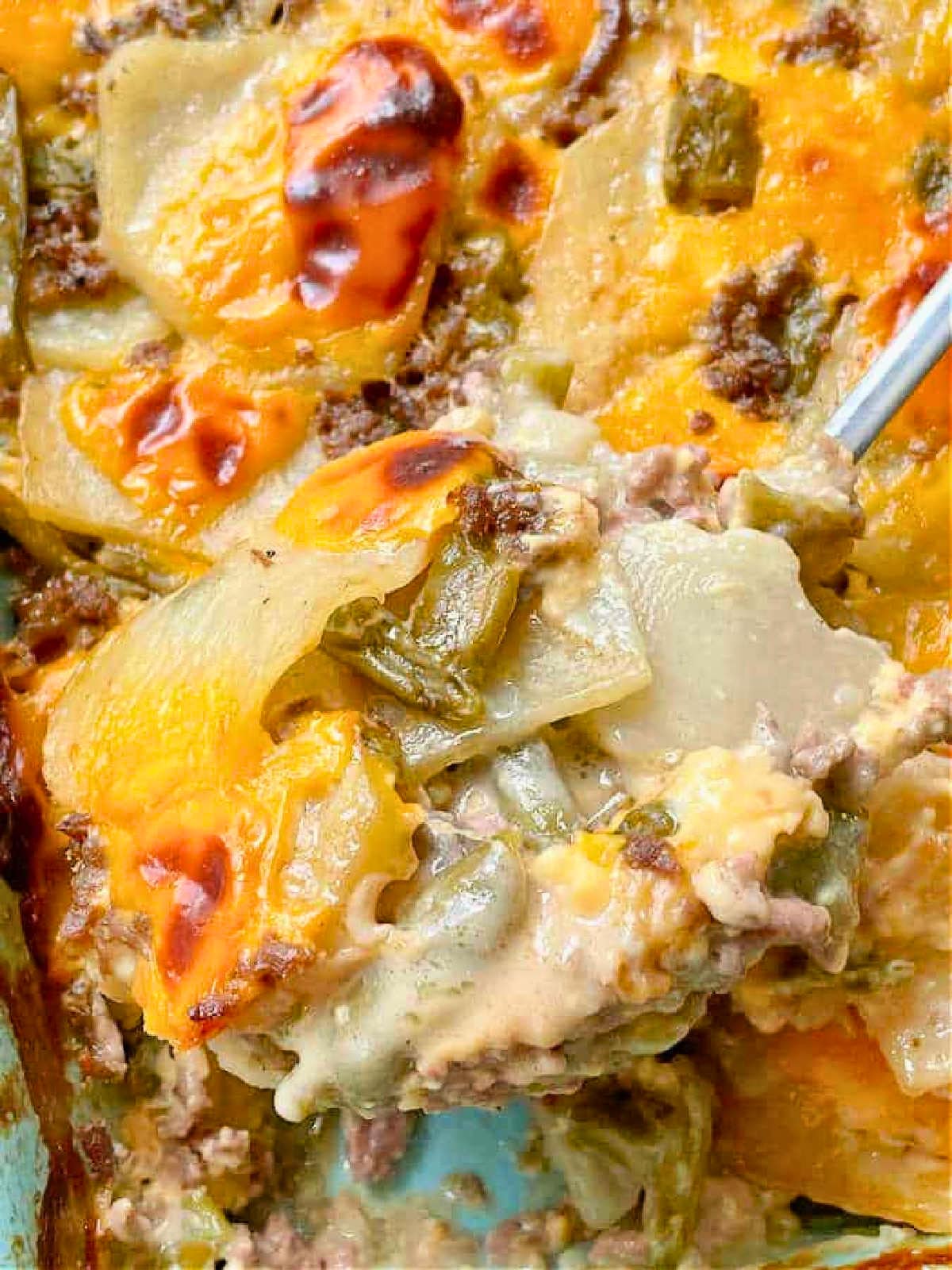 serving a spoonful of casserole from the baking dish