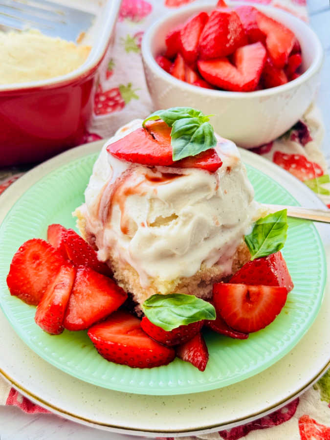 a plated slice of strawberry balsamic shortcake topped with vanilla gelato