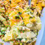 serving a spoonful of chicken broccoli pasta casserole from the baking dish