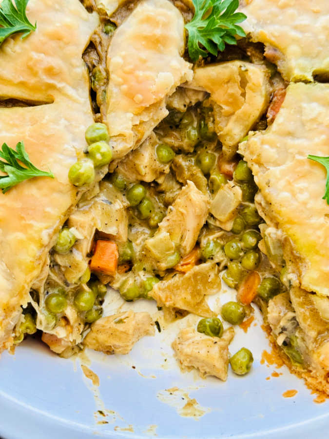 close up of the chicken filling spilling out from the crust