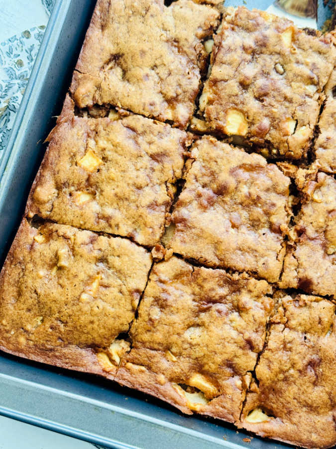 a pan of sour cream apple squares sliced and ready to serve