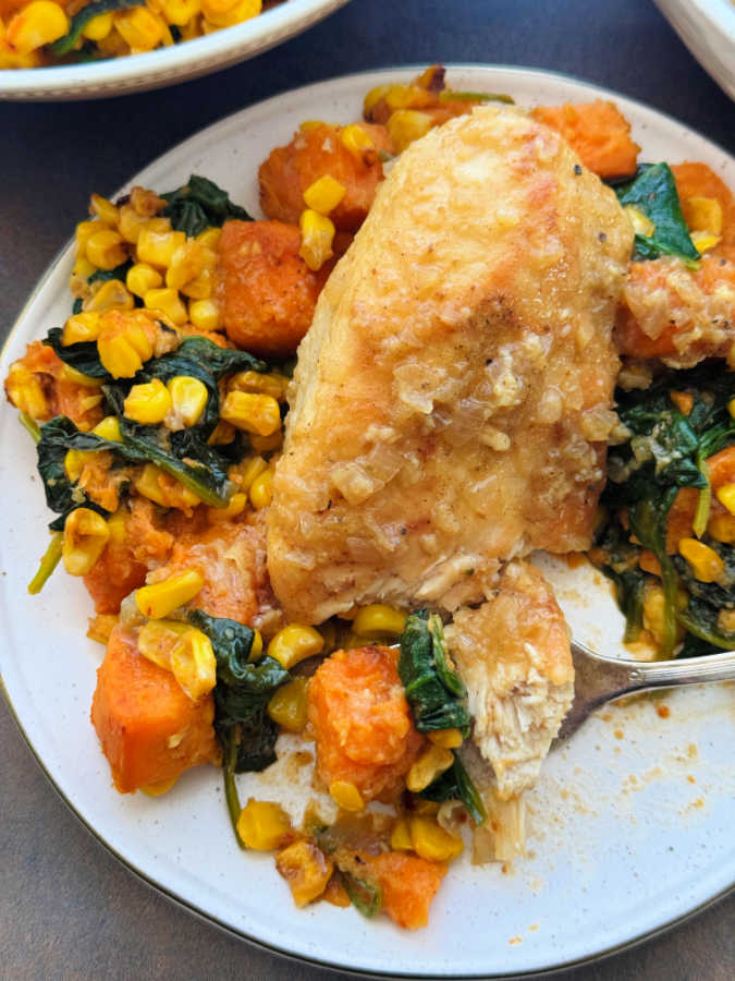 taking a bite of apple cider glazed chicken