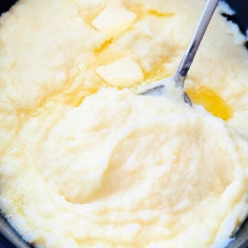 a crock full of creamy mashed potatoes ready to serve
