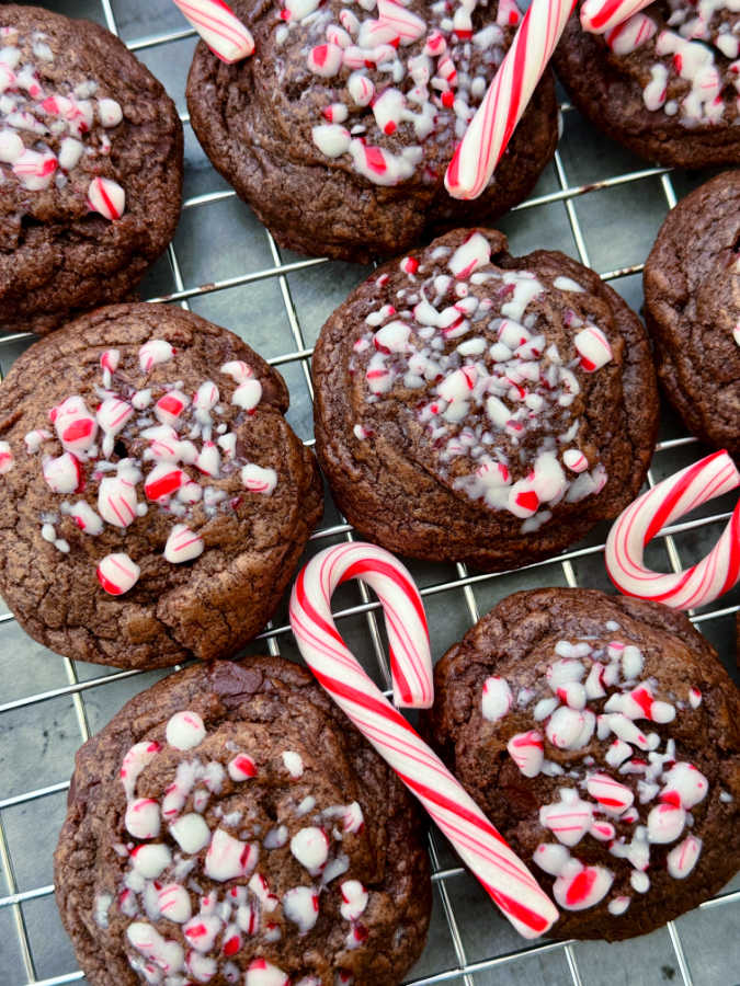 peppermint chocolate cookies and mini candy canes displayed on a cooling rack
