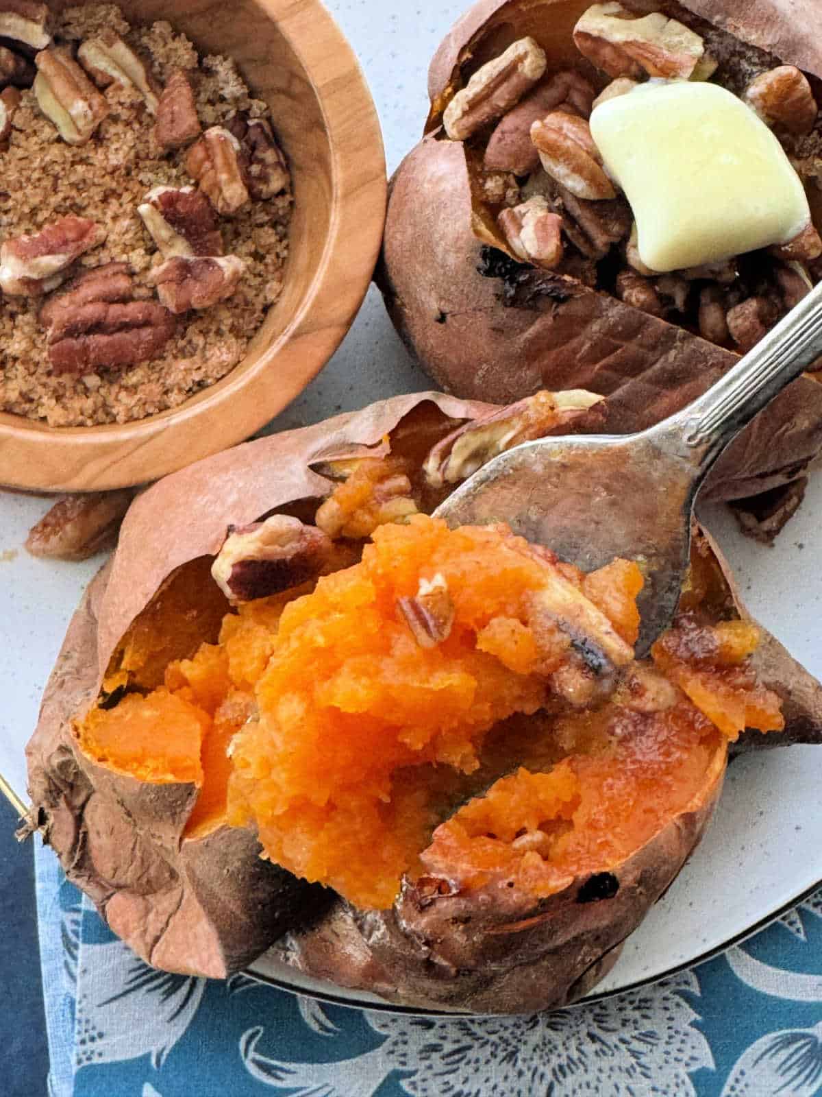 taking a bite of an air fryer roasted sweet potato