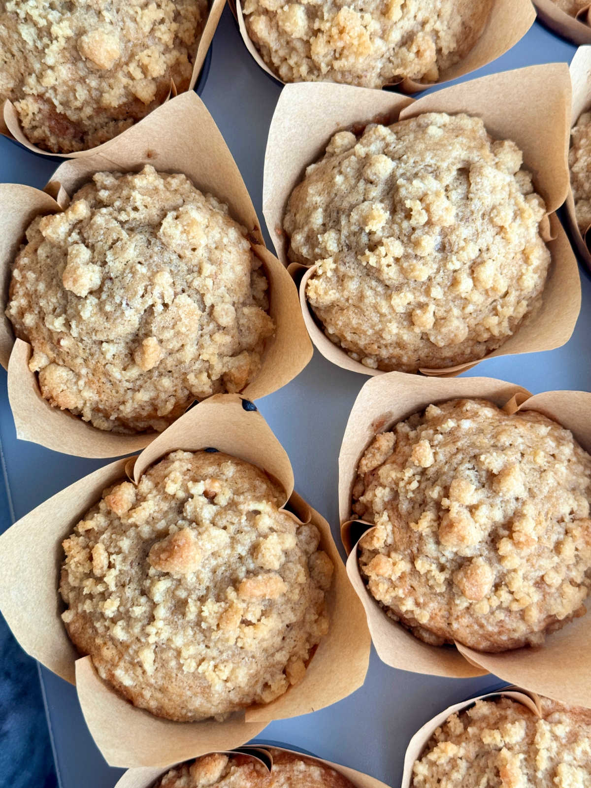 banana bread muffins cooling in a muffin tin