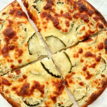 cooked pickle pizza sliced into four pieces