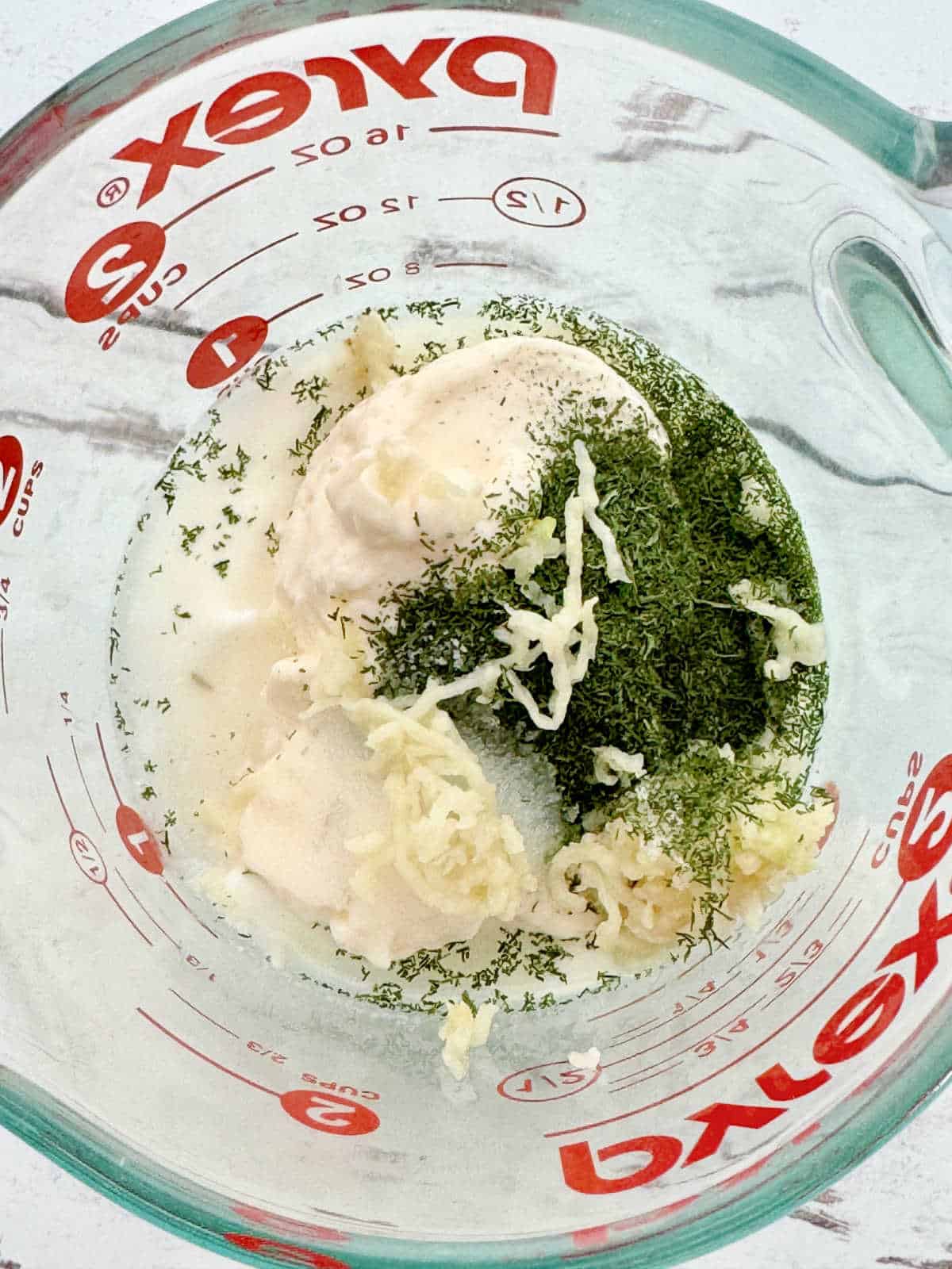 mixing together the creamy white sauce ingredients