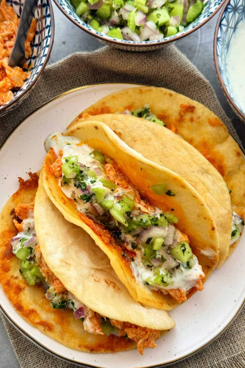 Buffalo chicken tacos are an easy weeknight dinner combining crispy cheddar tortillas with buffalo chicken, Ranch dressing and celery salsa. via @foodtasticmom