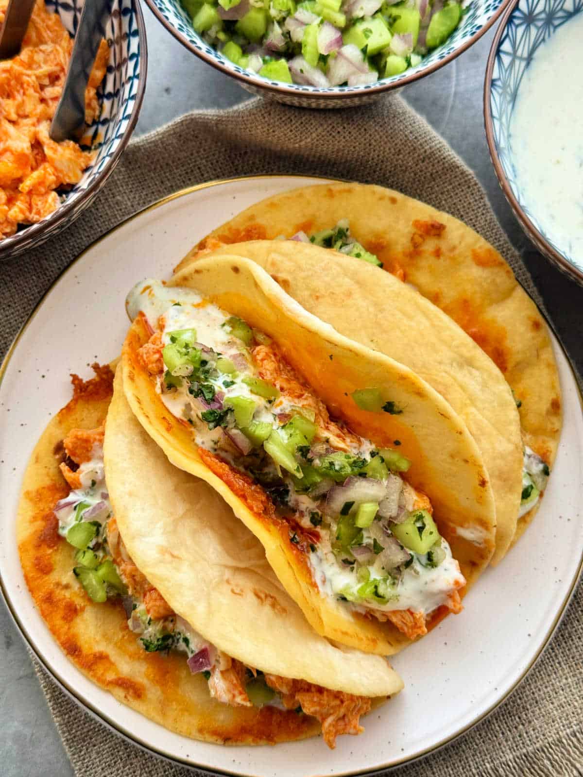three buffalo chicken tacos plated and ready to serve