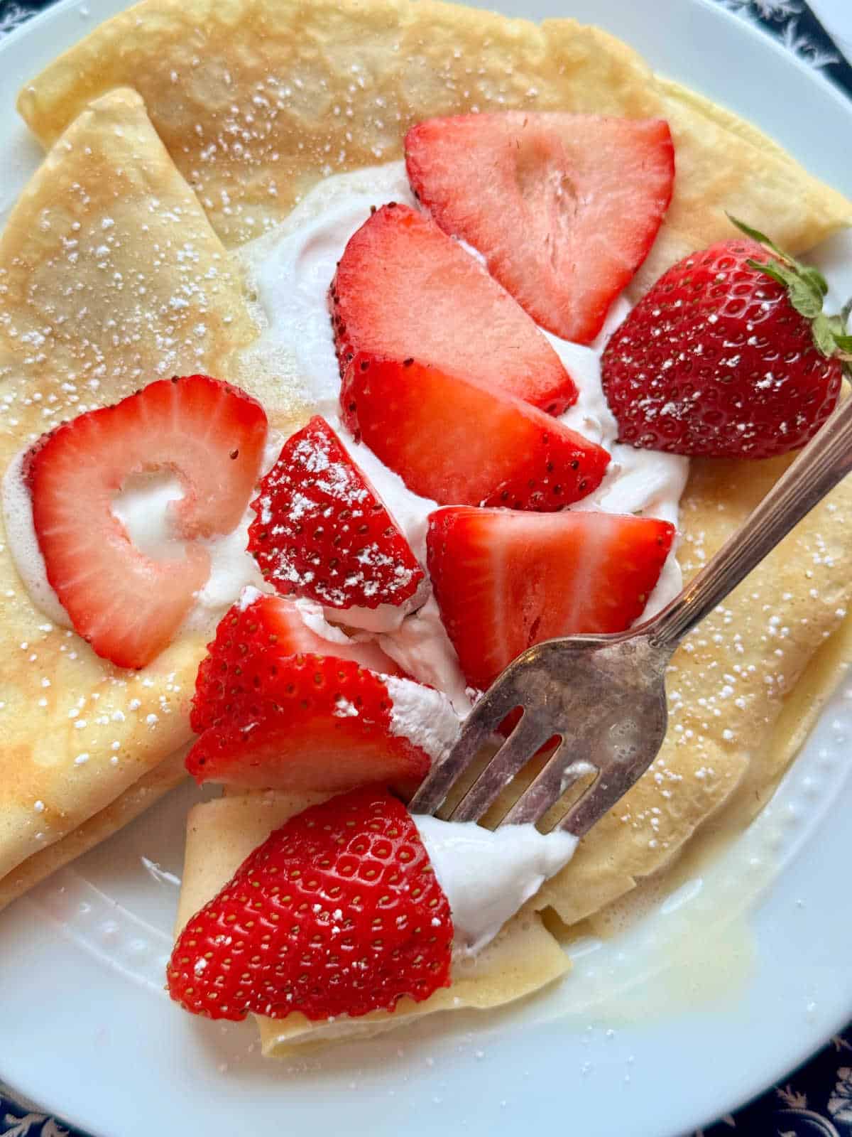 showing the plated crepes with a bite taken out