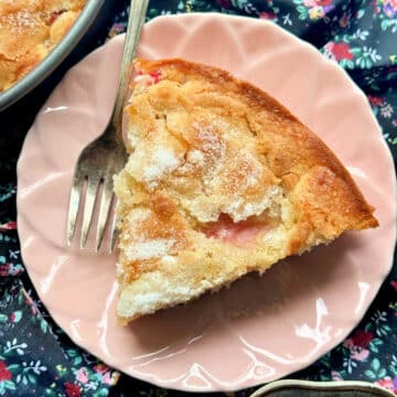 a slice of sugared rhubarb cake on a pale pink plate