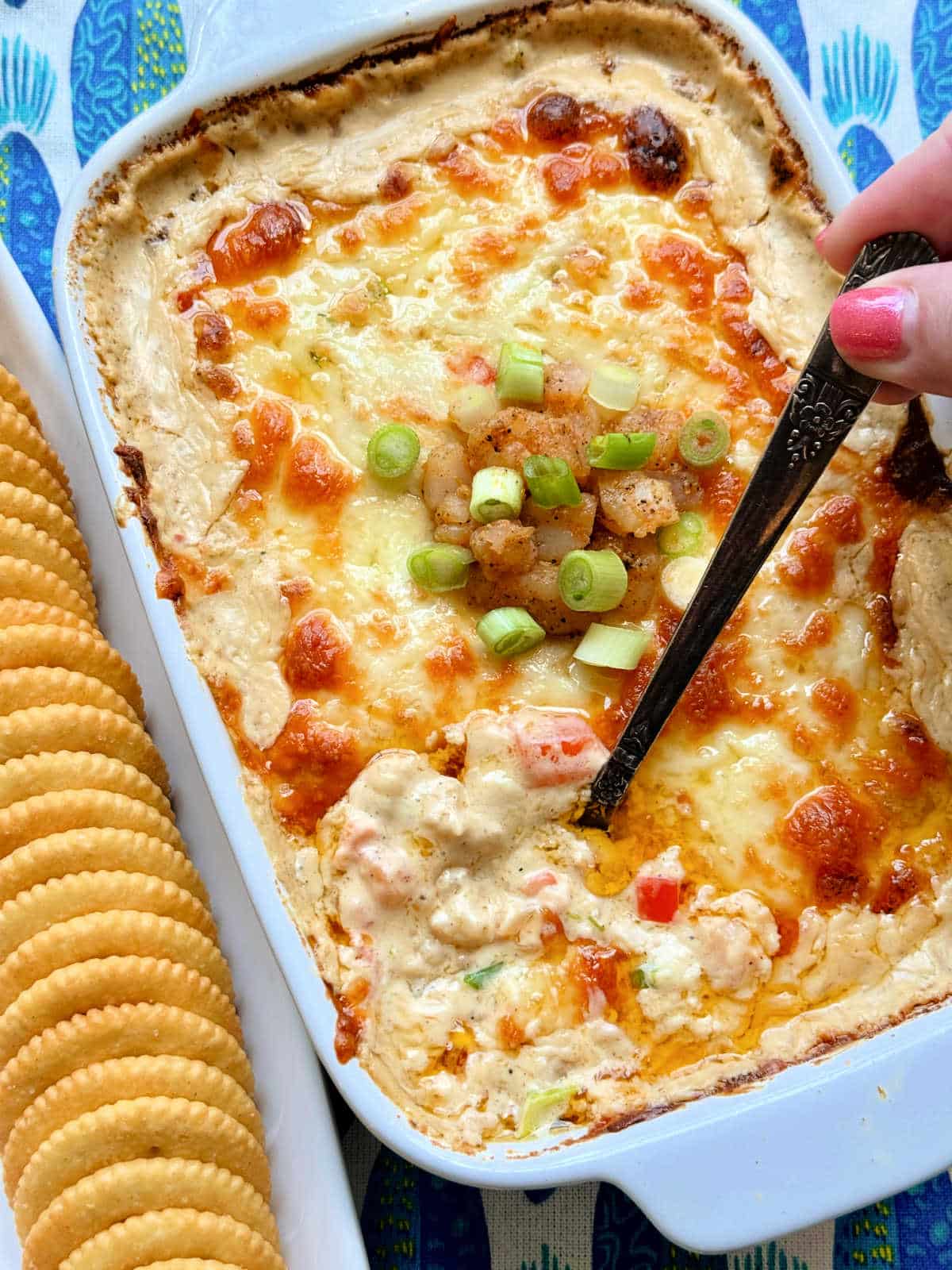 dish of cajun shrimp dip with a dish of Ritz crackers