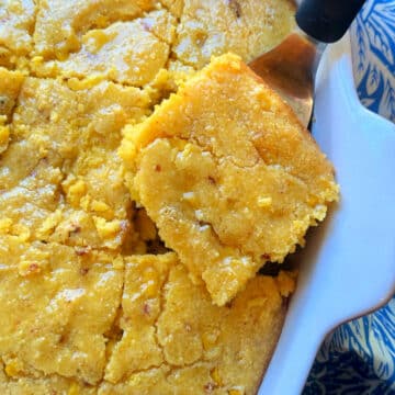 serving a square of cornbread casserole from the baking dish