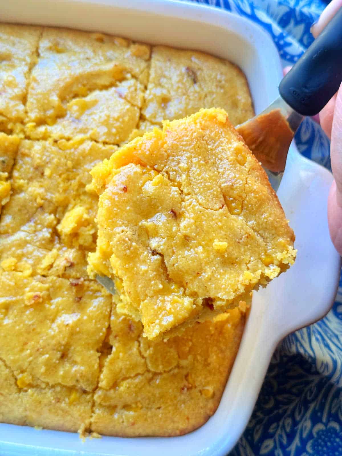 honey butter glazed cornbread casserole, sliced and ready to serve