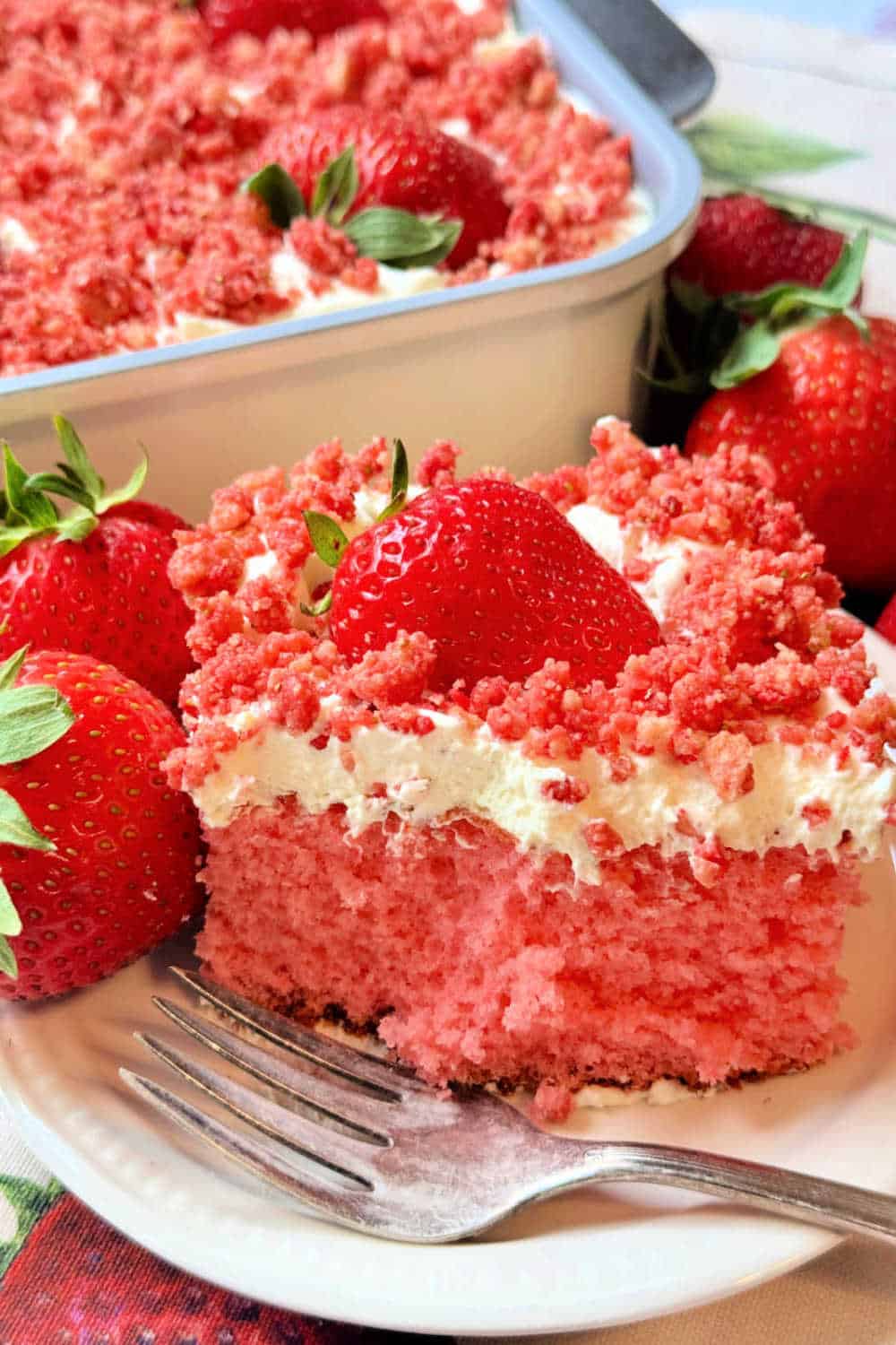 My strawberry crunch cake recipe is a pink hued sheet cake made with white cake mix and crunch topping like the ice cream bar. via @foodtasticmom
