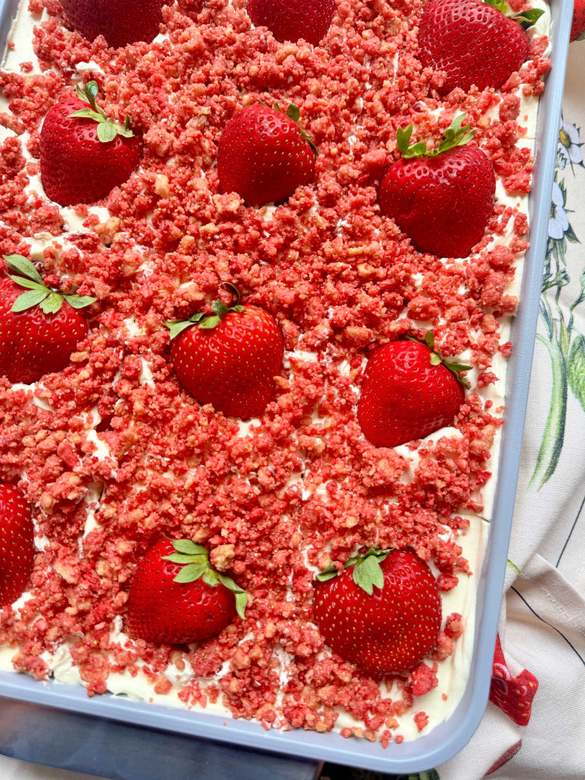 strawberry crunch cake garnished with fresh strawberries