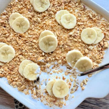 a serving spoon ready to serve banana pudding from the dish