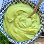 a bowl of freshly blended bean butter, made with white beans, parsley, olive oil, lemon juice and salt