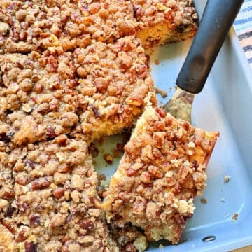 serving a slice of cinnamon coffee cake from the pan