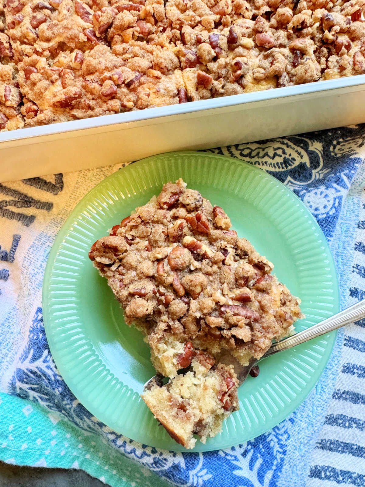 plated slice of cinnamon coffee cake with a bite taken