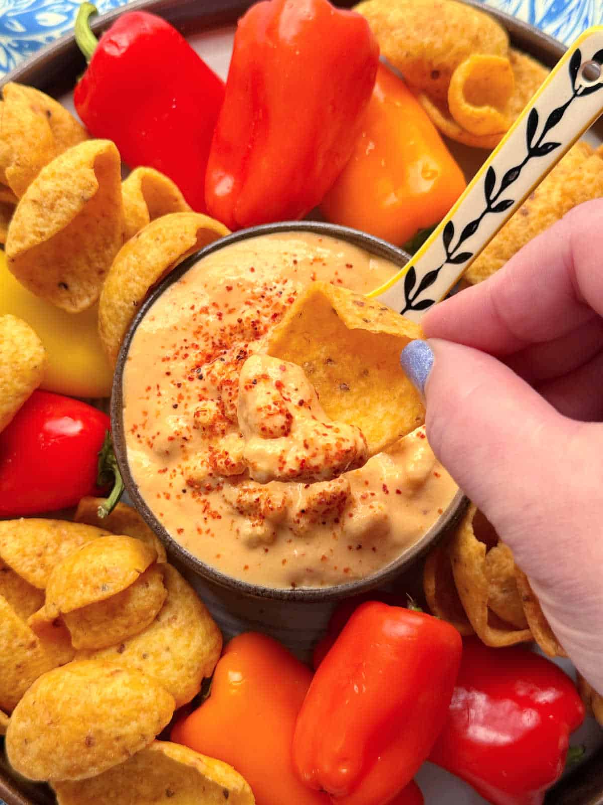 dipping a Frito scoop into the corn dip