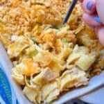 serving a spoonful of tuna noodle casserole from the baking dish