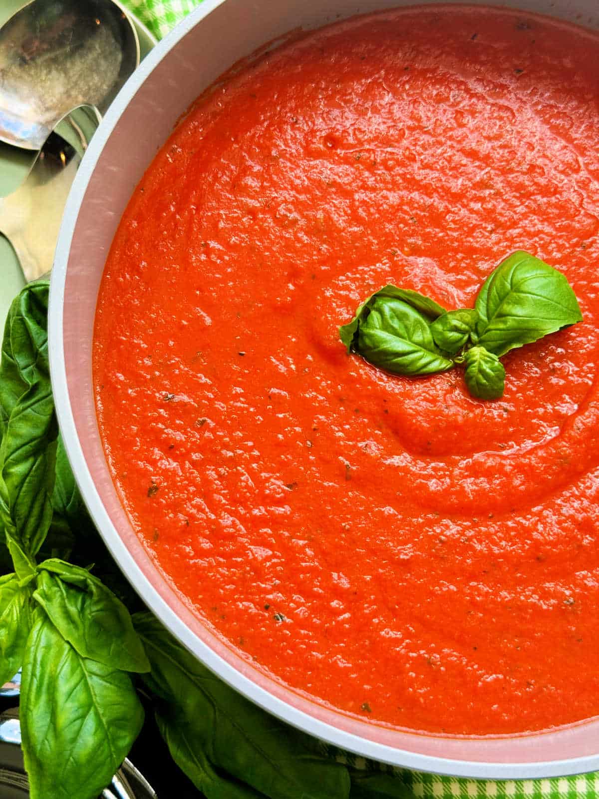 a pot of freshly made tomato basil soup ready to serve
