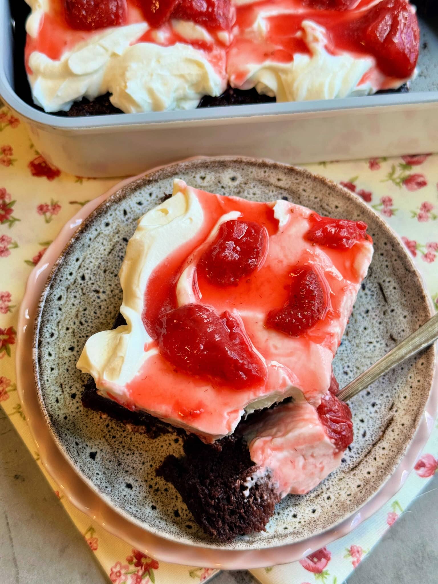 a plated slice of cake with a bite removed
